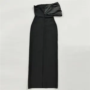 Detailed view of an elegant black bandage maxi dress with asymmetric satin shoulder detail