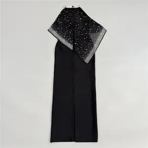 Detail view of a black bandage evening gown with a glittering rhinestone shawl