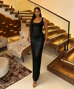 Detailed view of a sexy black bandage maxi dress on a model in a luxury interior.