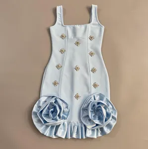 Detail view of light blue bandage dress with rhinestone clusters and large satin rose ruffles