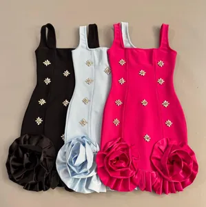 Detail view of rhinestone flower embellishments and rose hem on three colored dresses