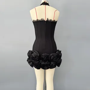 Back detail view of black bandage mini dress featuring large 3D fabric roses at hemline