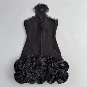 Close-up of black bandage dress featuring 3D rose skirt and lace halter neck detail