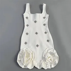 Detailed view of a sexy white bandage dress with rhinestones and 3D rose ruffles.