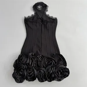 Detailed view of black bandage dress with halter neck, lace trim, and 3D rose hem