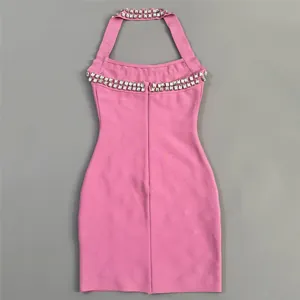 Close-up detail of a pink halter neck bodycon dress featuring sparkling rhinestone trim