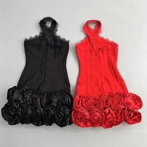 Detail view of black and red halter bandage dresses with 3D rose hem decoration