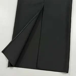 Close-up detail view of a sexy black bandage dress featuring a high front slit design.