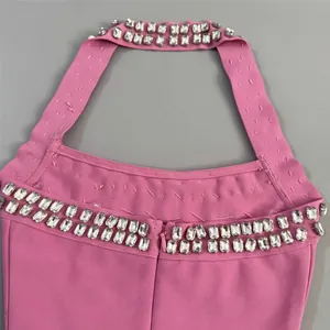 Close-up of the elegant rhinestone embellishments on the halter neck of a pink bandage dress