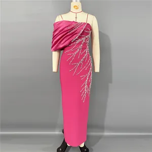 Detailed view of an elegant fuchsia pink evening gown featuring intricate silver rhinestone patterns