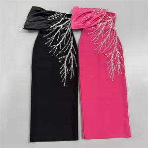 Detailed view of black and pink bandage evening dresses with rhinestone branches