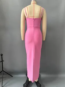 Back view of pink bodycon bandage maxi dress on mannequin for evening wear
