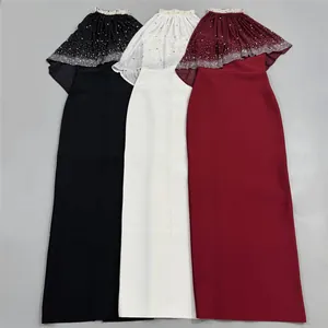 Detail view of elegant rhinestone cape evening dresses in black, white, and wine red