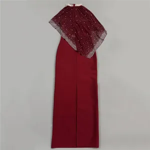 Close-up view of elegant wine red evening dress with rhinestone cape and back slit