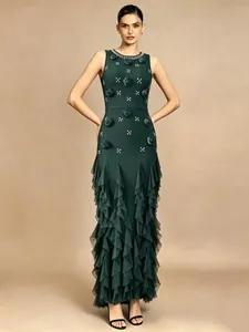 Exquisite detailed view of a dark green bandage dress with 3D floral accents and ruffles.