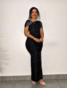 Elegant black bandage maxi dress with rhinestone detailing and off-shoulder design