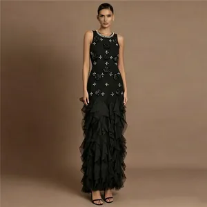 Elegant black mermaid evening gown with 3D floral accents and ruffled tiered skirt.