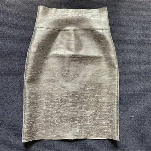 Detail of metallic silver bandage mini skirt featuring a high waist and stretchy fit