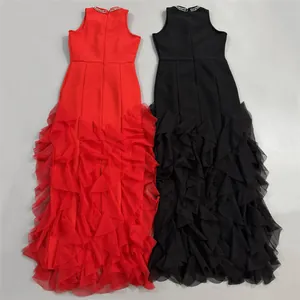 Floor-length red and black evening gowns featuring high collars and ruffled tulle skirts.