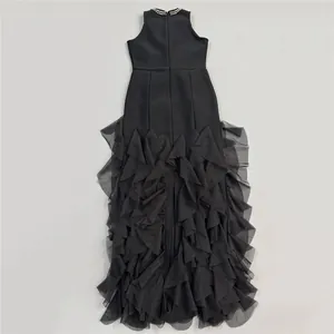 Elegant sleeveless black evening gown with a high waist and layered tulle ruffle skirt detail