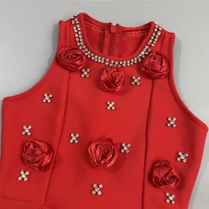 Close-up of red bandage dress with 3D satin roses and sparkling rhinestones detail.