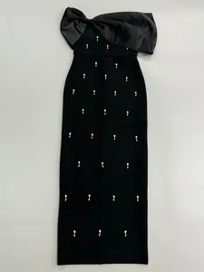 Elegant black bandage dress with rhinestone accents and a large satin bow.