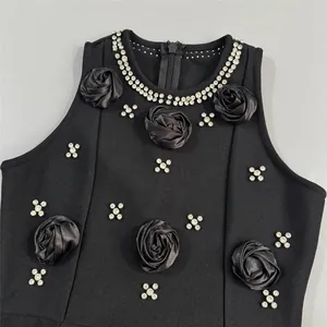 Detailed view of elegant black bandage dress featuring 3D floral roses and sparkling rhinestones