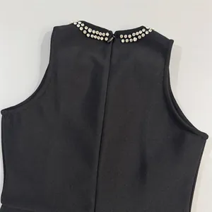 Detailed view of black bandage dress with rhinestone collar and back zipper closure