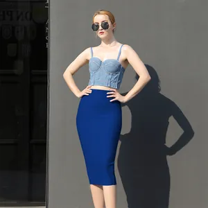 Close-up of a high-waisted blue bandage skirt on a model in bright sunlight