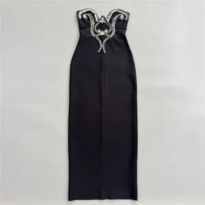 Detailed view of an elegant black strapless bandage dress with luxury rhinestone