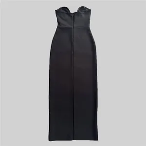Detailed view of a sleek black strapless bandage dress with a back slit detail.
