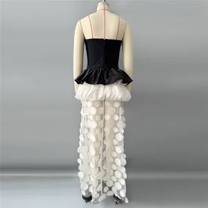 Back view detail of a strapless black and white gown with textured sheer skirt