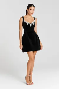 Elegant black bodycon mini dress featuring a crystal-embellished neckline and straps