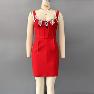 Detailed view of a red bandage mini dress with exquisite rhinestone neckline on a mannequin