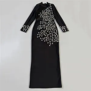 Elegant black long-sleeved bandage maxi dress with intricate silver branch embroidery
