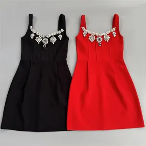 Detailed view of black and red bandage mini dresses with floral rhinestone neckline embellishments
