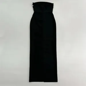 Close-up detail of a sleek black strapless bandage evening gown with rhinestone accents