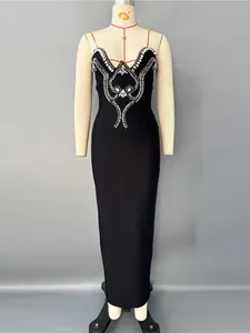 Elegant black strapless bandage maxi dress with rhinestone detailing on mannequin
