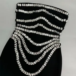 Exquisite detail of black bandage dress featuring rows of sparkling clear rhinestones