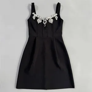 Sleeveless black bandage mini dress featuring crystal rhinestone neckline embellishments