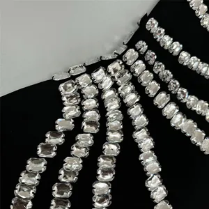 Close-up of sparkling rectangular rhinestone fringe on a sleek black bandage evening dress
