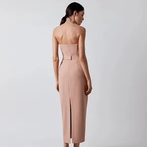 Detailed back view of a pink strapless bodycon bandage midi dress with a back slit
