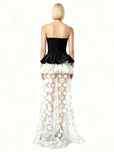 Elegant strapless black and white contrast evening gown with polka dot tulle skirt