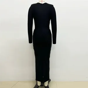 Back view of an elegant black long-sleeved bandage maxi dress shown on a mannequin