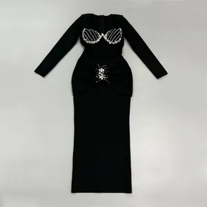 Detailed view of the luxury crystal embellishments on this black long-sleeved bandage dress