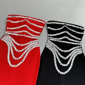 Detailed view of red and black bandage dresses featuring elegant rhinestone drapes