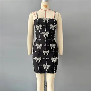 Exquisite close-up of a black bandage dress with pearl grid and rhinestone bows