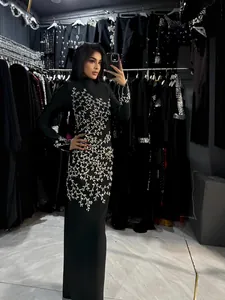 Elegant black long-sleeved maxi dress featuring intricate silver crystal branch embroidery