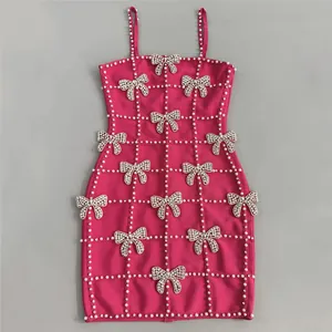 Elegant fuchsia bandage dress featuring crystal bow accents and pearl grid detailing.