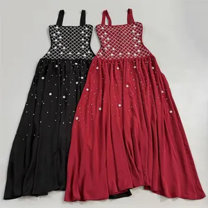 Detailed view of two elegant long evening dresses with a rhinestone lattice bodice